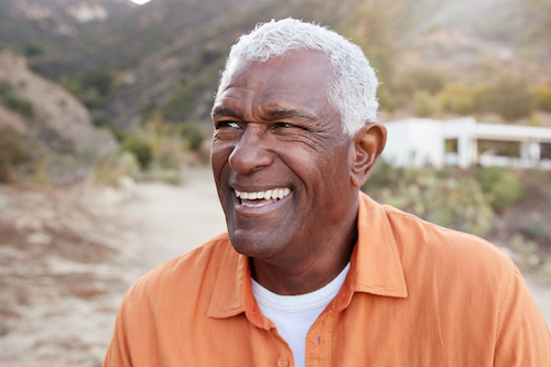 Senior man smiling outside